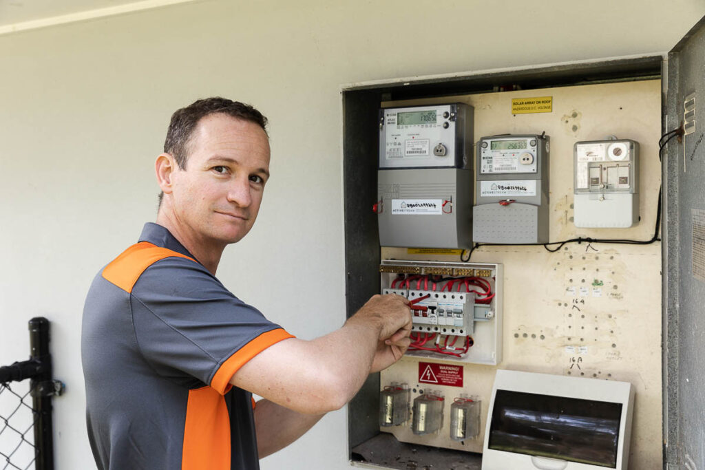 Comfort Electrical Services working on a switch board with fuses